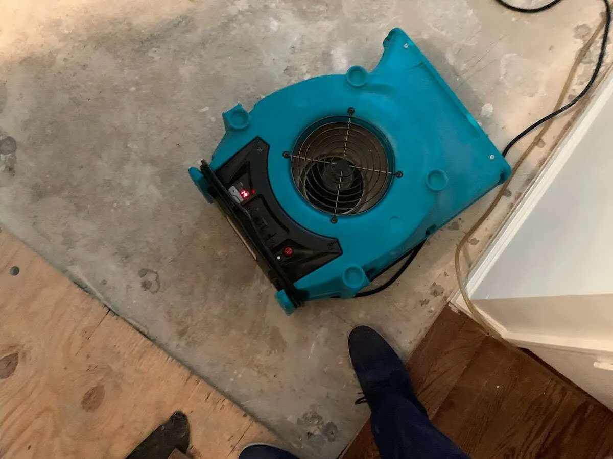 Air mover drying subfloor during Leak Detection & Repair in Kalamazoo